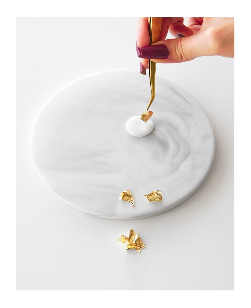 Placing silver flakes on hot wax Placing silver flakes on hot wax