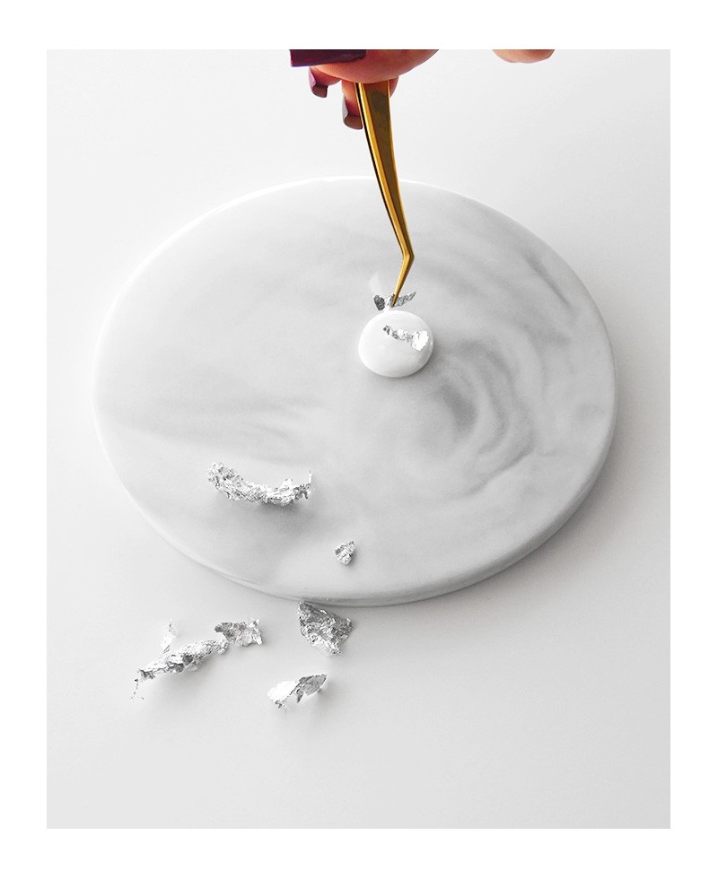 Placing silver flakes on hot wax Placing silver flakes on hot wax